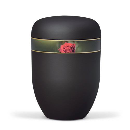 Die Naturstoffurne ist anthrazitfarben mit einem Velours-Dekorband, das eine Rosenblüte zeigt, und hat eine ovale Form mit einem leicht gewölbten Deckel.