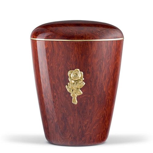 Naturstoffurne mit Wurzelholzeffekt in rötlicher Farbe, glänzender Folienbeschichtung, verziert mit einer goldenen Rosenblüte und einem goldenen Band.