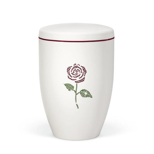 Naturstoffurne in Weiß-Matt mit einem dekorativen Rosenmotiv aus farblichen Crystal Elements und einem roten Dekorband am Deckel.