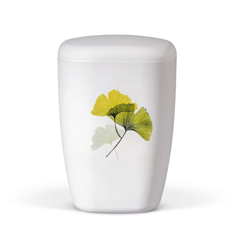 Die Naturstoffurne in Weiß Matt hat eine ovale Form und zeigt ein dekoratives Motiv von Ginkgo-Blättern in Gelb und Grün auf der Vorderseite.