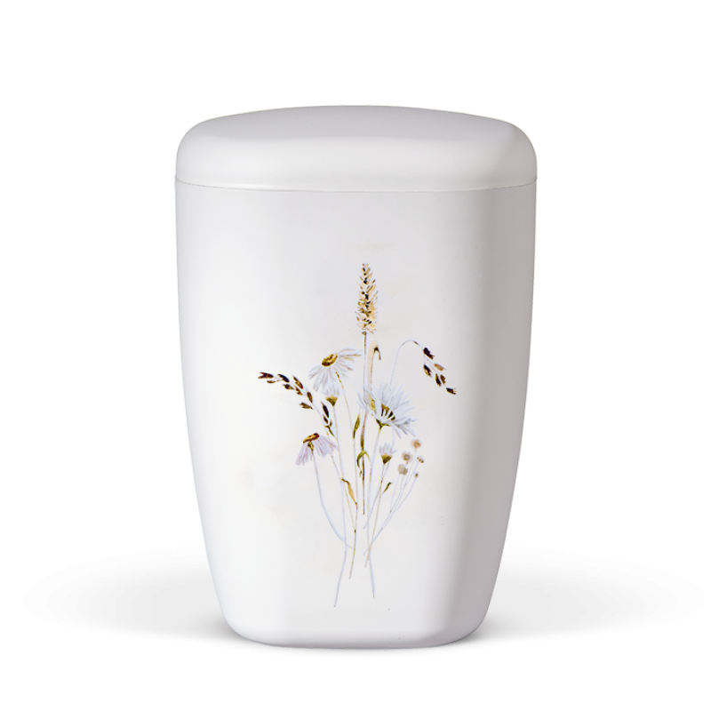 Die Naturstoffurne in mattem Weiß hat eine ovale Form und zeigt eine dekorative Illustration von Wildblumen, darunter Margariten und Kräuter.