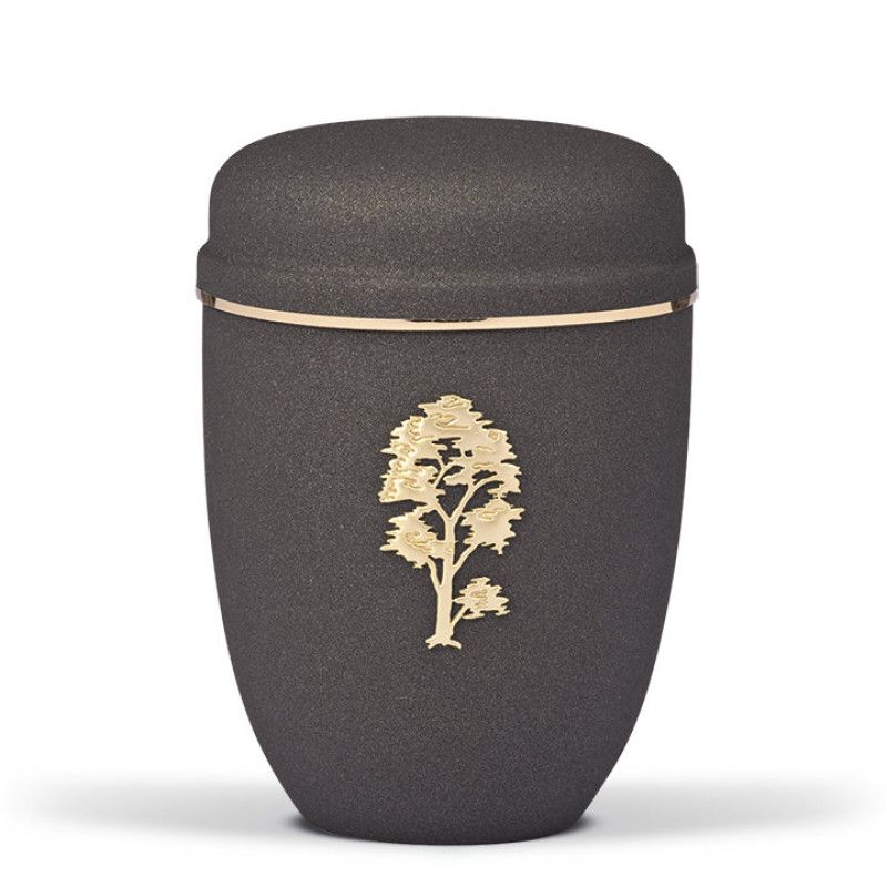 Die Stahlurne in Grau Anthrazit mit Velours-Oberfläche hat eine runde Form, einen goldenen Band und zeigt ein Baum-Motiv in Gold auf der Vorderseite.