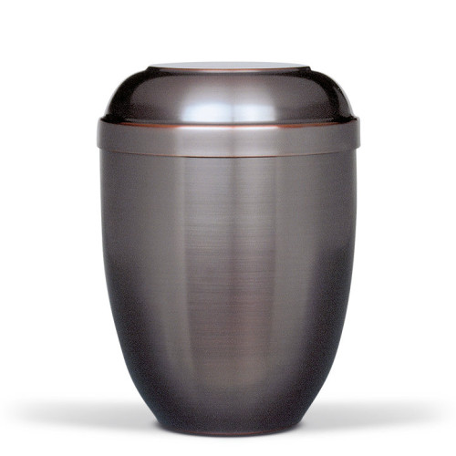 Die Urne CUPATAN in Dunkel hat eine ovale Form, ist aus Metall gefertigt und zeigt eine matte Oberfläche mit glänzendem Deckel.