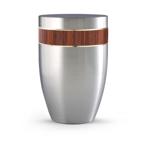 Die Urne der Edition Melina ist aus gebürstetem Edelstahl gefertigt, hat eine ovale Form und ist mit einem Zebrano-Holzband verziert.