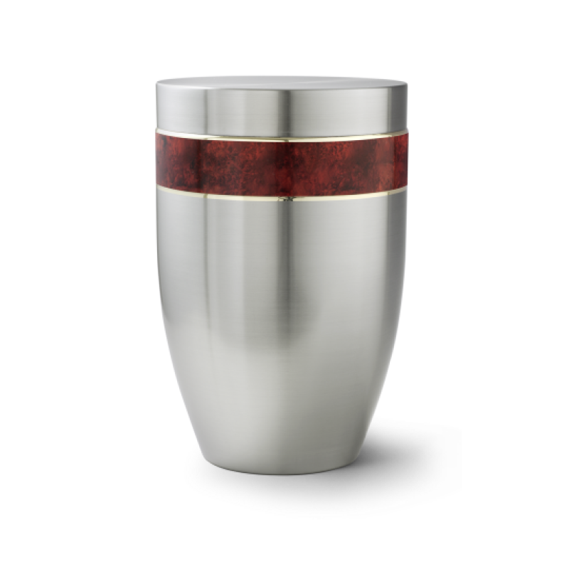 Die Urne der Edition Melina ist aus gebürstetem Edelstahl gefertigt, hat eine ovale Form und eine dekorative rotbraune Wurzelholz-Einlage mit goldfarbener Linie.