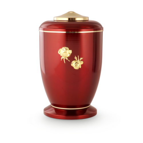 Die Urne ist aus poliertem Stahl in glänzendem Rot, hat eine ovale Form, goldene Röschen-Dekoration und einen goldenen Deckel.