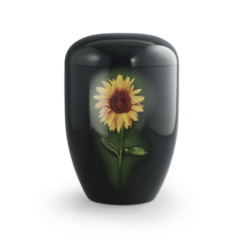 Die schwarze Urne aus Klavierlack zeigt eine Sonnenblume mit grünen Blättern und hat eine ovale Form, sichtbar in einer Gesamtansicht.