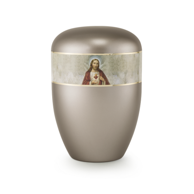 Die Urne in perlmutt fumé ist oval geformt, hat eine matte Oberfläche und zeigt ein religiöses Motiv mit Heiland auf einem dekorativen Band.