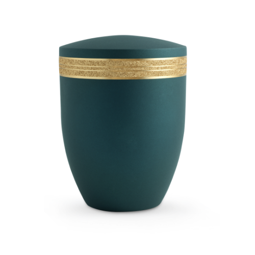 Die Urne aus der Edition Krypta ist in einem samtigen Petrolton gehalten, mit einem mattgoldenen, glitzernden Dekorstreifen um die Mitte und hat eine ovale Form.