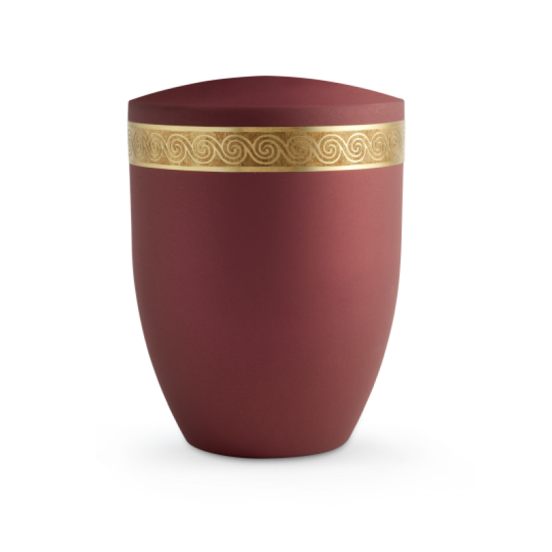 Die Urne der Edition Krypta ist in Samton Rubin gehalten, hat eine ovale Form und ist mit einem mattgoldenen Schneckendekor altgolden eingefasst.