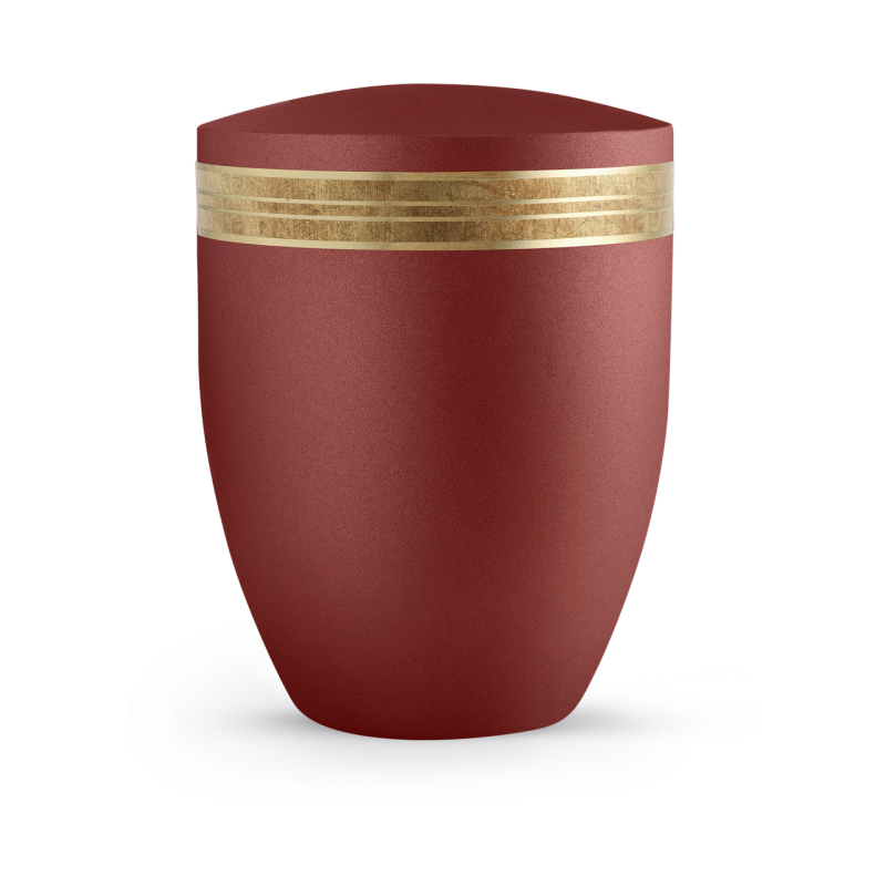 Die Urne der Edition Krypta ist in Samton Rubin gehalten, hat eine matte goldene Einfassung mit altgoldenem Dekor und zeigt eine geschwungene, ovale Form.