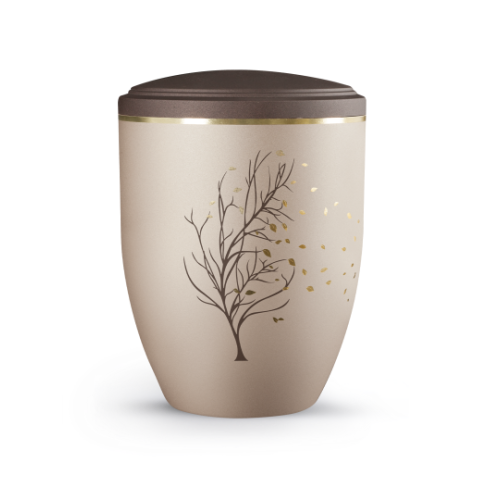 Die Urne der Edition La Vida ist champagnerfarben mit einer goldenen Baum- und Blättergrafik, hat eine runde Form und einen braunen Deckel.