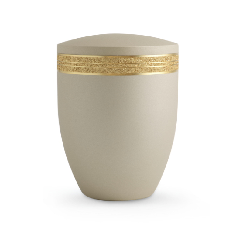 Die Urne der Edition Krypta ist in Samton Champagner gehalten, hat eine matte Oberfläche und ist mit einem glitzernden, mattgoldenen Dekor eingefasst.