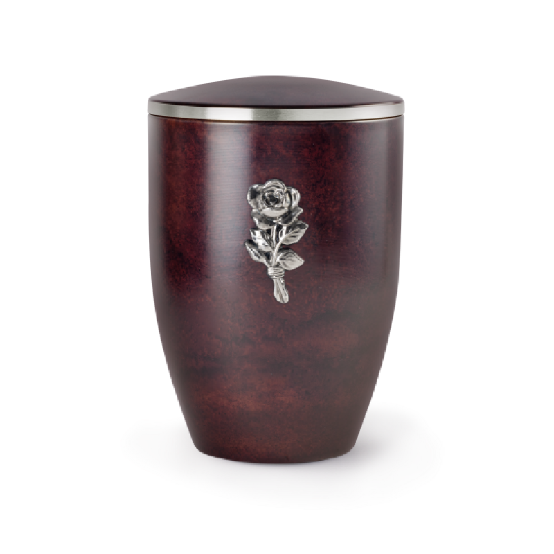 Die Urne der Edition Melina in Rosenholzoptik hat eine ovale Form, ist dunkelrot und mit einer silbernen Rose sowie einem abnehmbaren Deckel verziert.