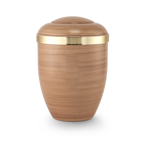 Die handbemalte Urne in Saharasandfarbe hat eine ovale Form, eine gebürstete Goldband-Applikation und ist biologisch abbaubar.