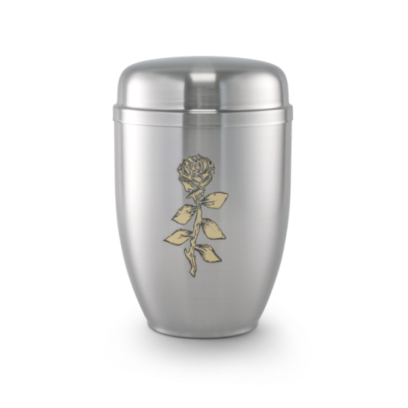 Die Urne Cestal von Goetz ist satiniert, in Silber gehalten und zeigt eine goldene Rose als Dekor, mit einer ovalen Form und einem abgerundeten Deckel.
