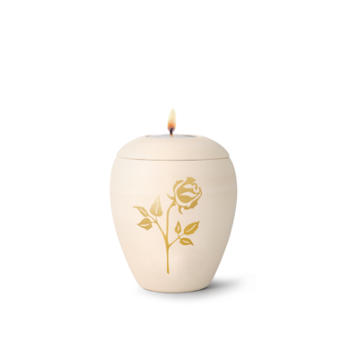Gedenklicht aus cremefarbener Keramik in Form einer Urne mit handbemalter goldener Rose, Gesamtansicht mit brennendem Docht.