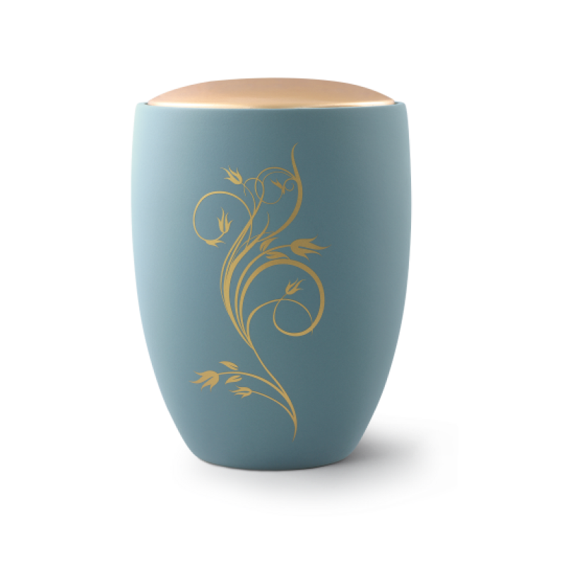 Die Urne aus der Edition Remember Me ist türkisfarben, aus Keramik gefertigt und zeigt ein florales Ornament in Gold, mit einem runden, hellen Deckel.