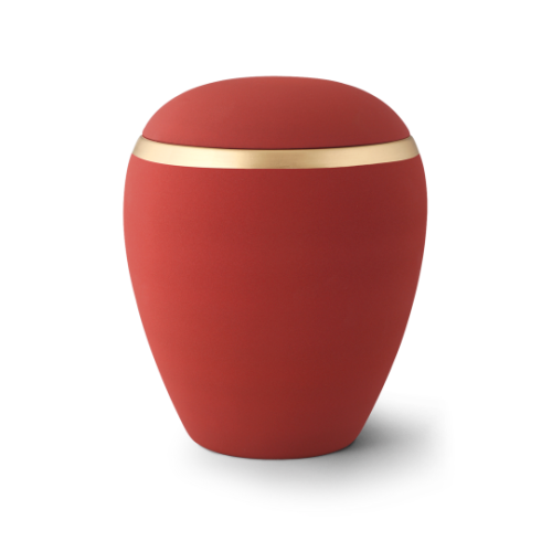 Die Urne aus der Edition Colour Line ist aus roter Keramik mit einem altgoldenen Dekorstreifen und hat eine runde, sanft geschwungene Form.