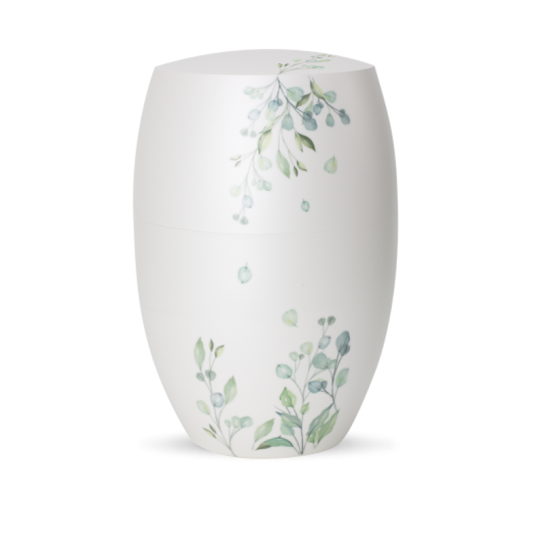 Die Urne aus der Edition Botanique ist in Perlmutt-Mattweiß gehalten und zeigt zarte Eukalyptus-Motive in sanften Grüntönen, mit ovaler Form und einem abnehmbaren Deckel.