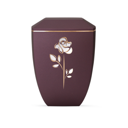 Die Urne aus der Edition Facette in Velvet Berry hat eine sechseckige Form, ist in dunkellila gehalten und zeigt eine goldene Rosenapplikation.