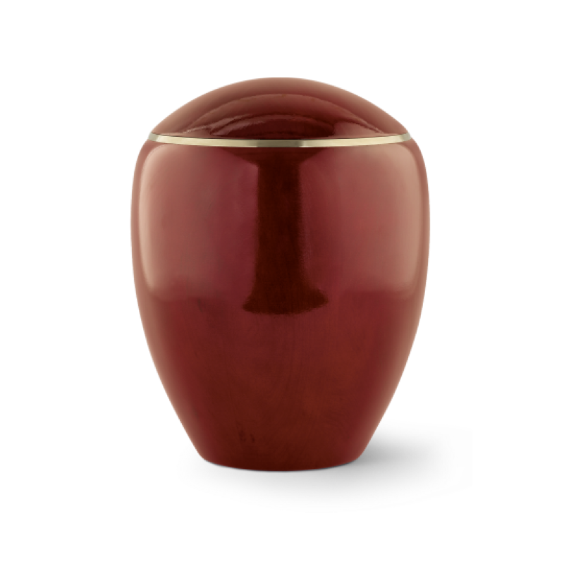 Die Urne aus der Edition Sevilla ist in hochglänzendem Mahagoni-Rot gehalten, hat eine ovale Form und einen schmalen Messingring am oberen Rand.