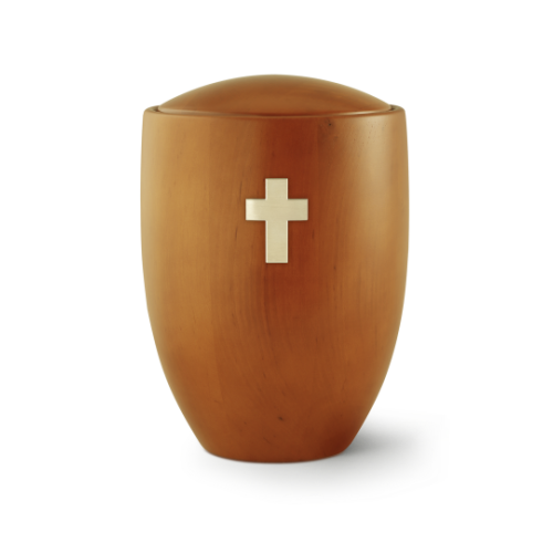 Die Urne der Edition Sevilla aus Erle und Mango hat eine ovale Form, ist in einem warmen Holzton gehalten und zeigt ein gebürstetes Messingkreuz auf der Vorderseite.