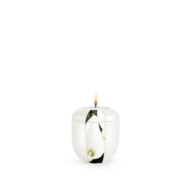 Ein gedenklicht in Form einer stilisierten Urne, aus Perlmutt mit einer Calla-Blüte, in weißer Farbe und mit einem sichtbaren Docht, Gesamtansicht.