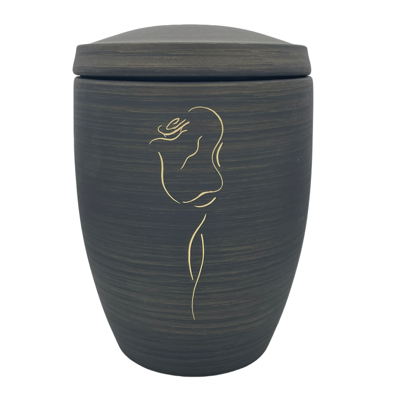 Die Alto Urne in dunklem Grau hat eine runde Form, einen abnehmbaren Deckel und zeigt eine goldene Rose als dekoratives Element.