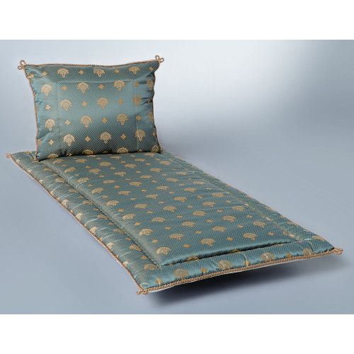 Jacquard Pesante in petrol mit goldenen Mustern, bestehend aus einer Matratze und einem Kissen, in Gesamtansicht auf einem hellen Hintergrund.